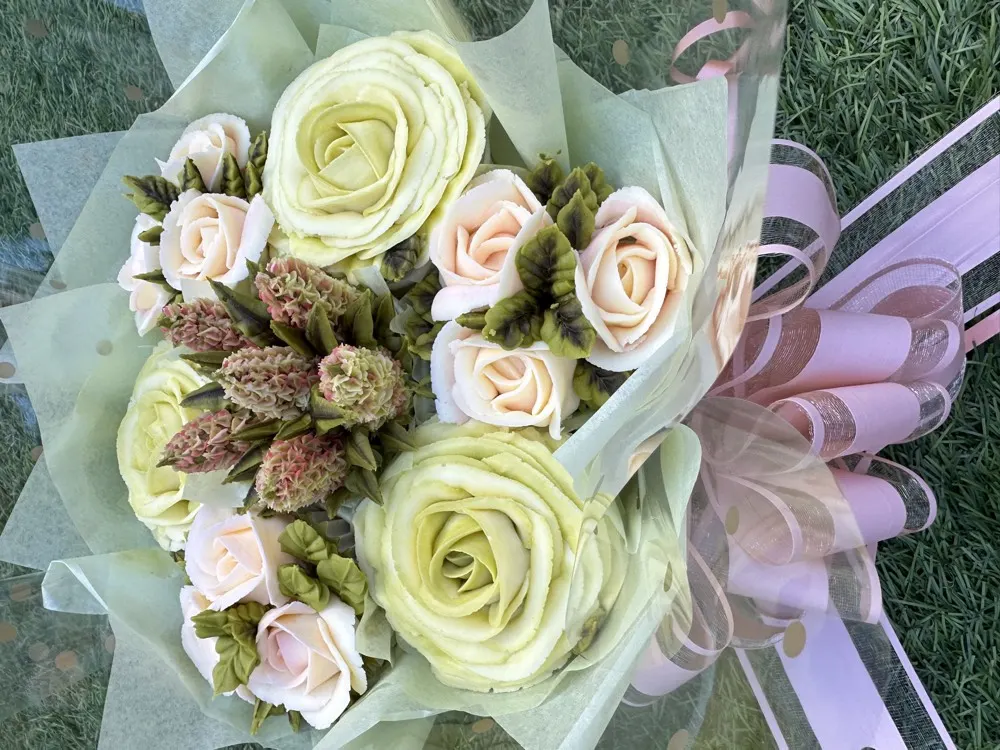 7 Deluxe cupcake bouquet with pistachio green and blush roses wrapped in pastel paper